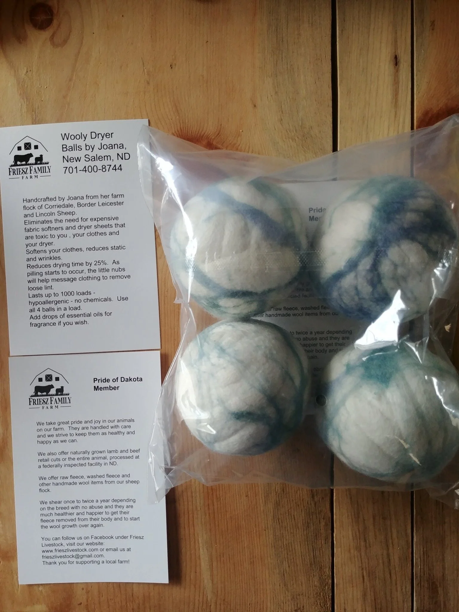 A set of four Friesz wool dryer balls with their instruction card
